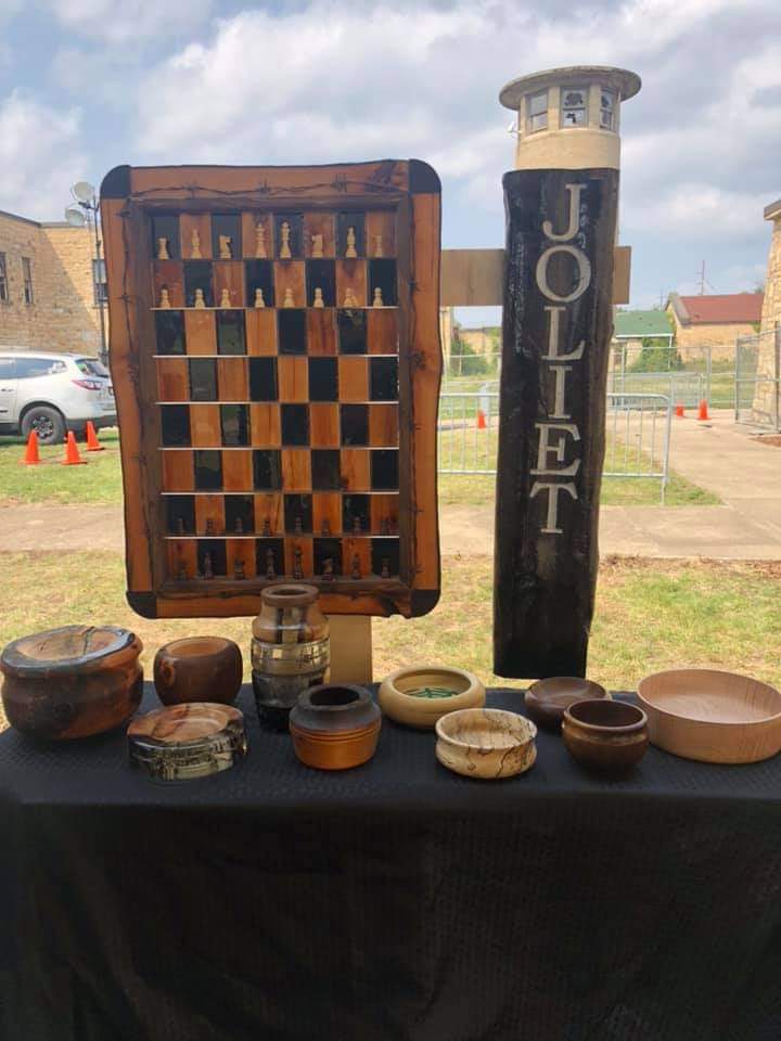 Table of wooden art bowls, chess board at the Old Joliet Prison