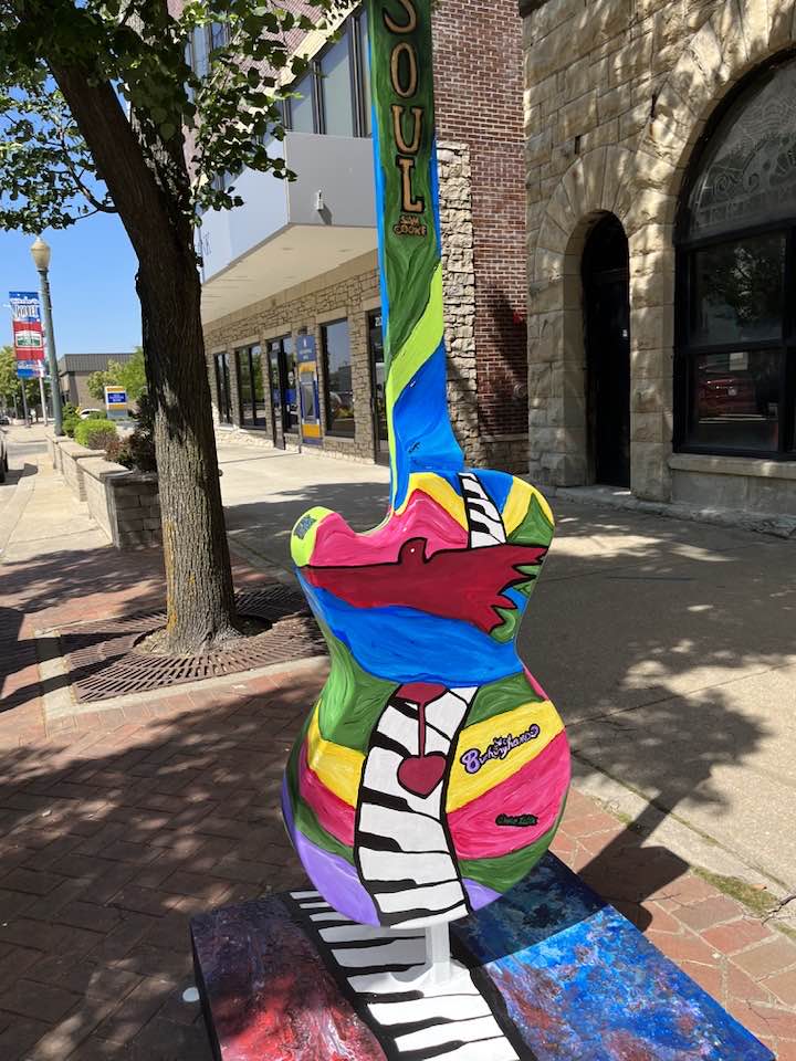 Statue of guitar with bright colors and piano keyboard