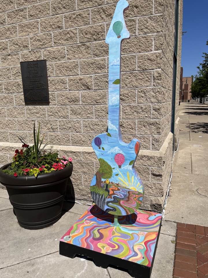 Guitar statue swirly tie-dyed pastel colors